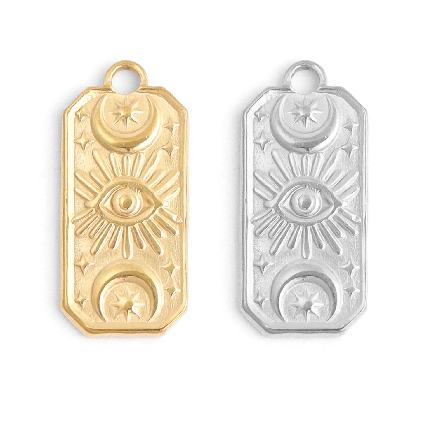 Gold and silver pendant with eye design on a white background