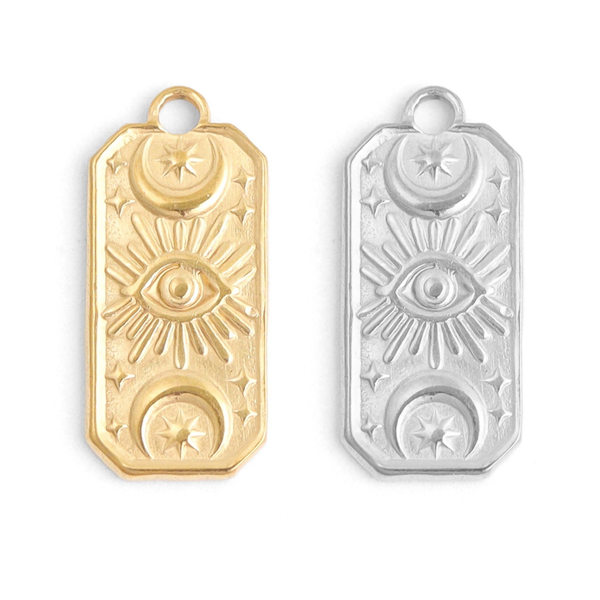 Gold and silver pendant with eye design on a white background