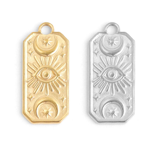 Gold and silver pendant with eye design on a white background