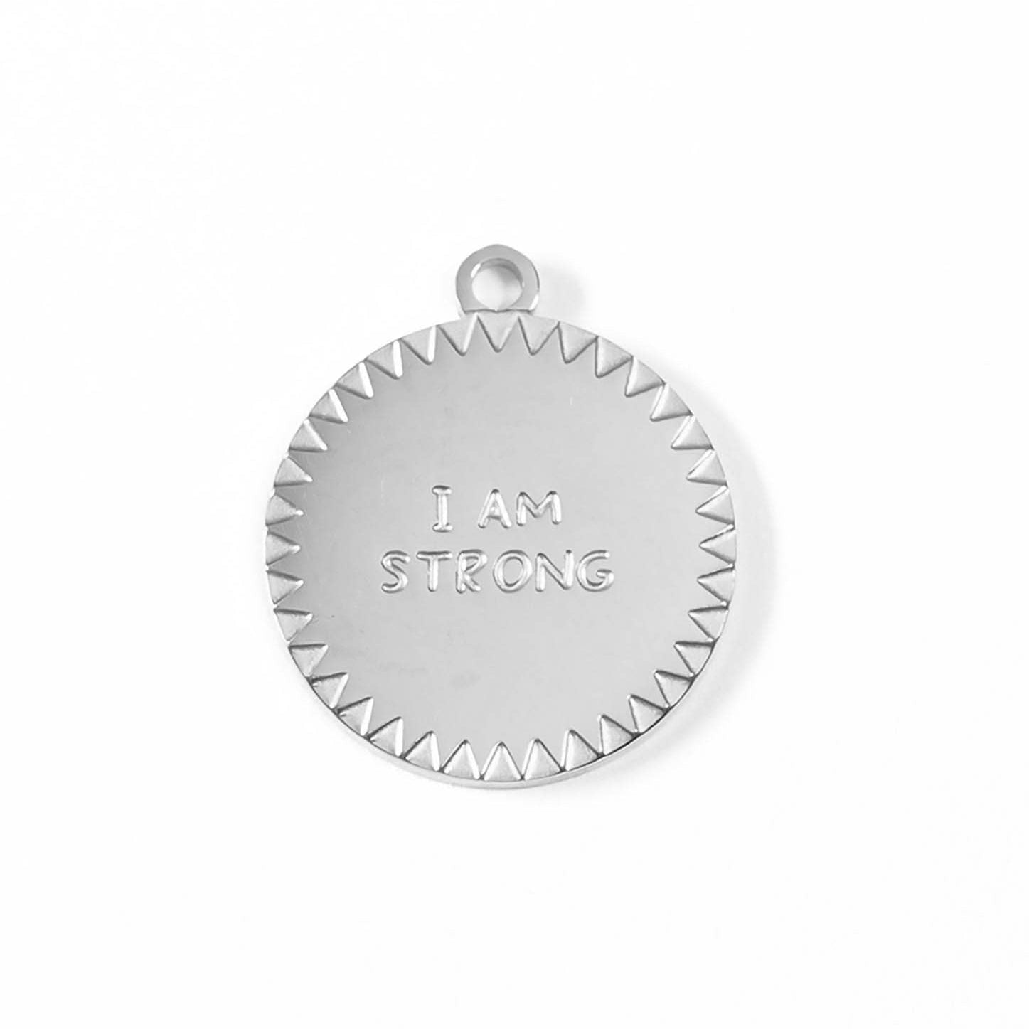 Silver pendant with 'I AM STRONG' engraving on a white background