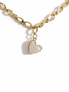 Gold chain necklace with a heart-shaped pendant on a white background
