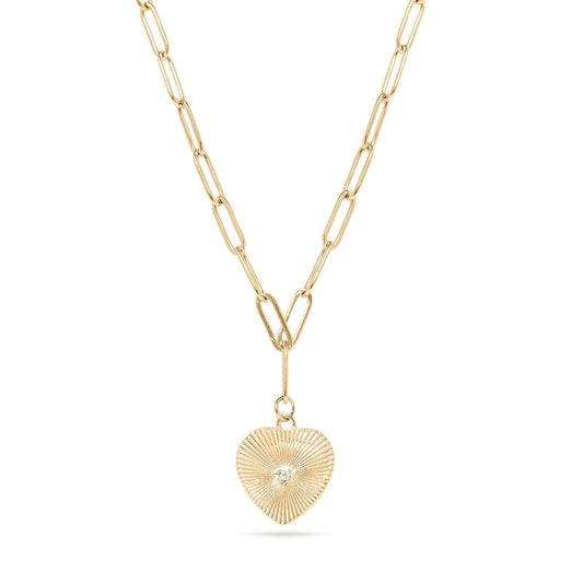 Gold necklace with a heart-shaped pendant on a white background