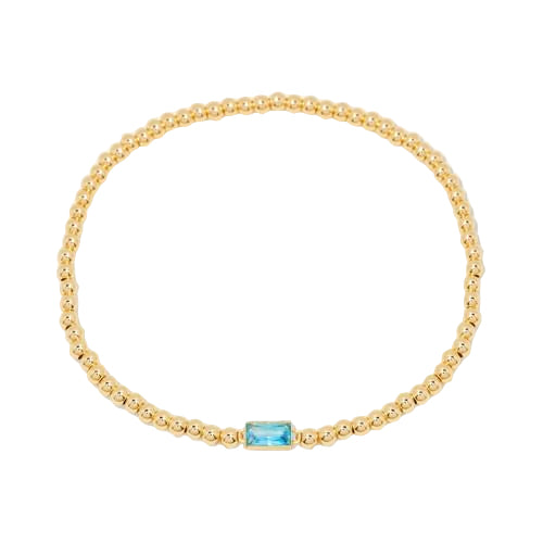Gold bracelet with a central gemstone on a white background