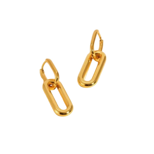 Gold hoop earrings on a beige background