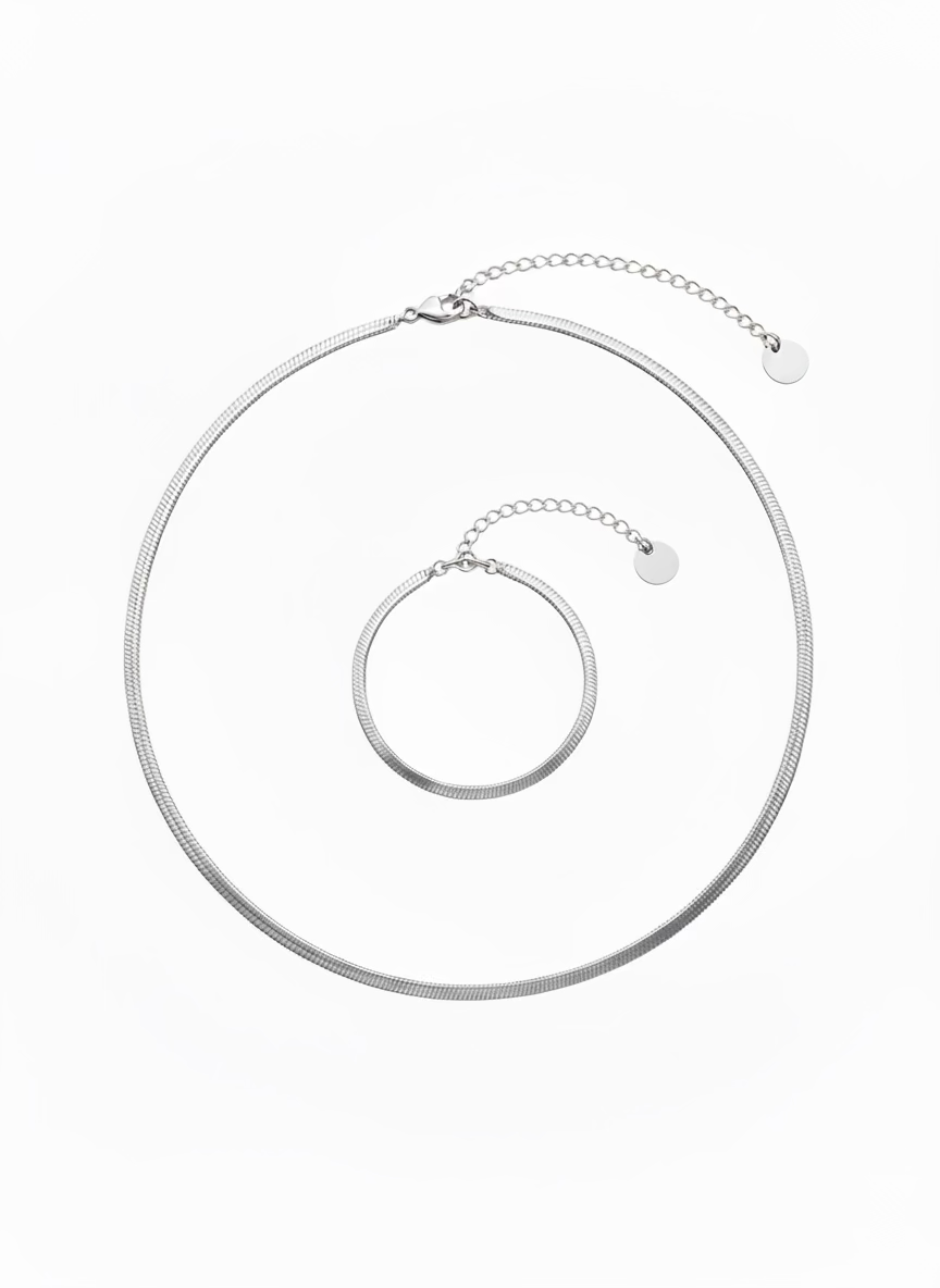 Silver necklace on a white mannequin bust against a white background