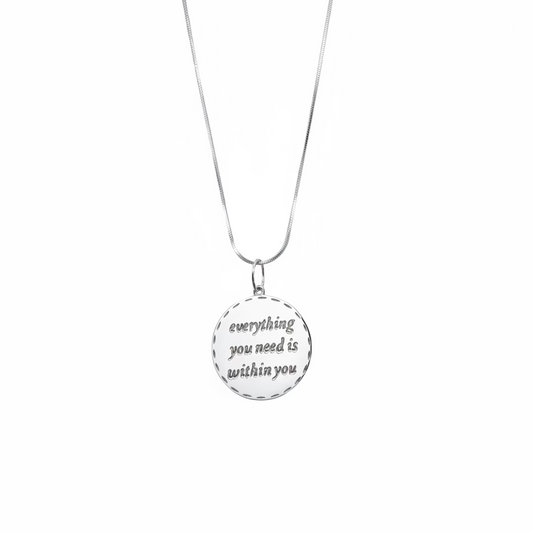 Necklace with a pendant that says 'everything you need is within you' on a white background