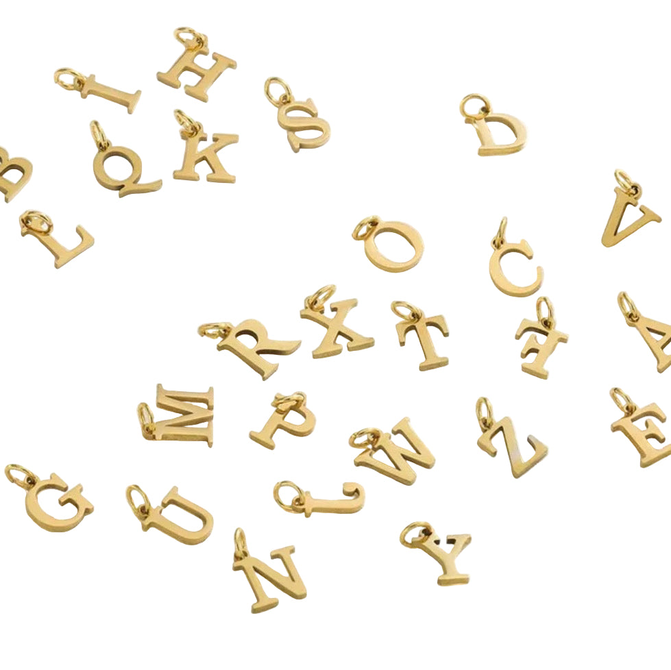Gold letter charms on a white background