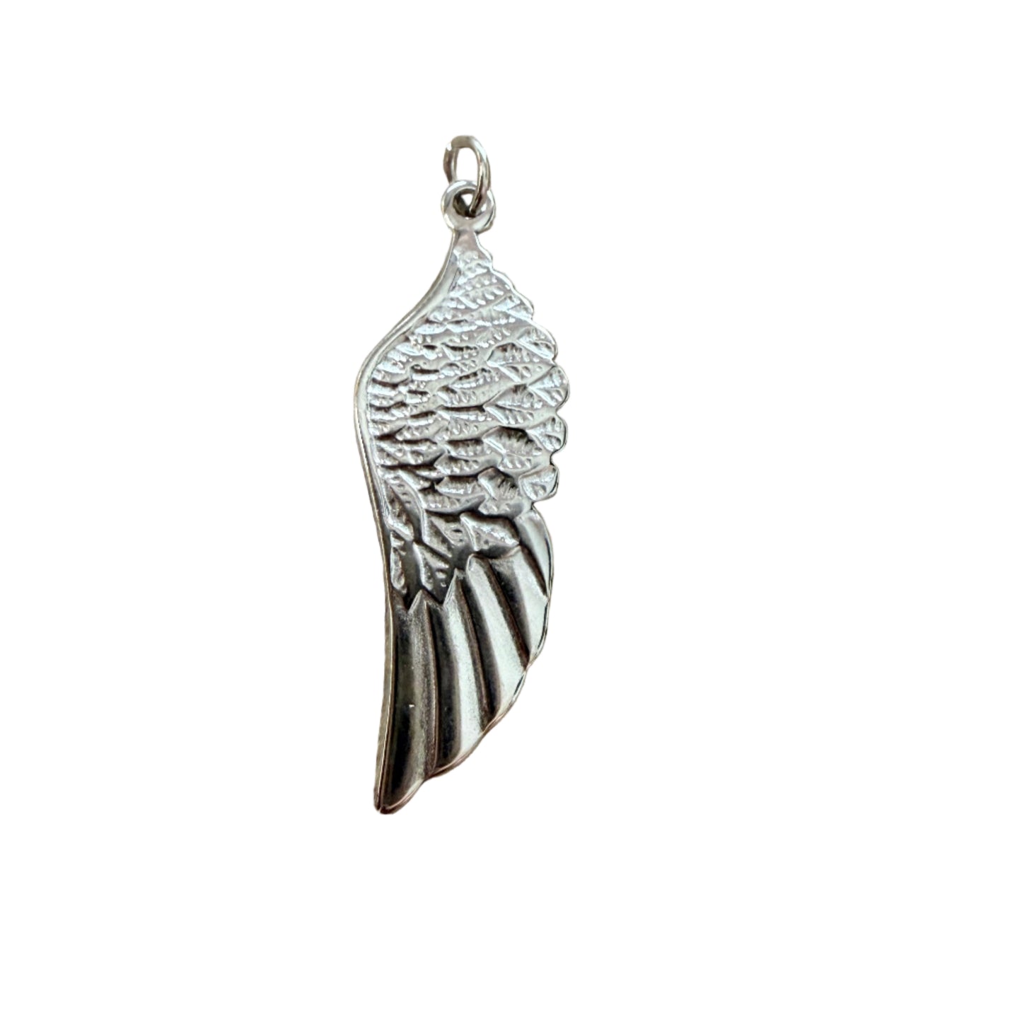 Silver angel wing pendant on a wooden surface