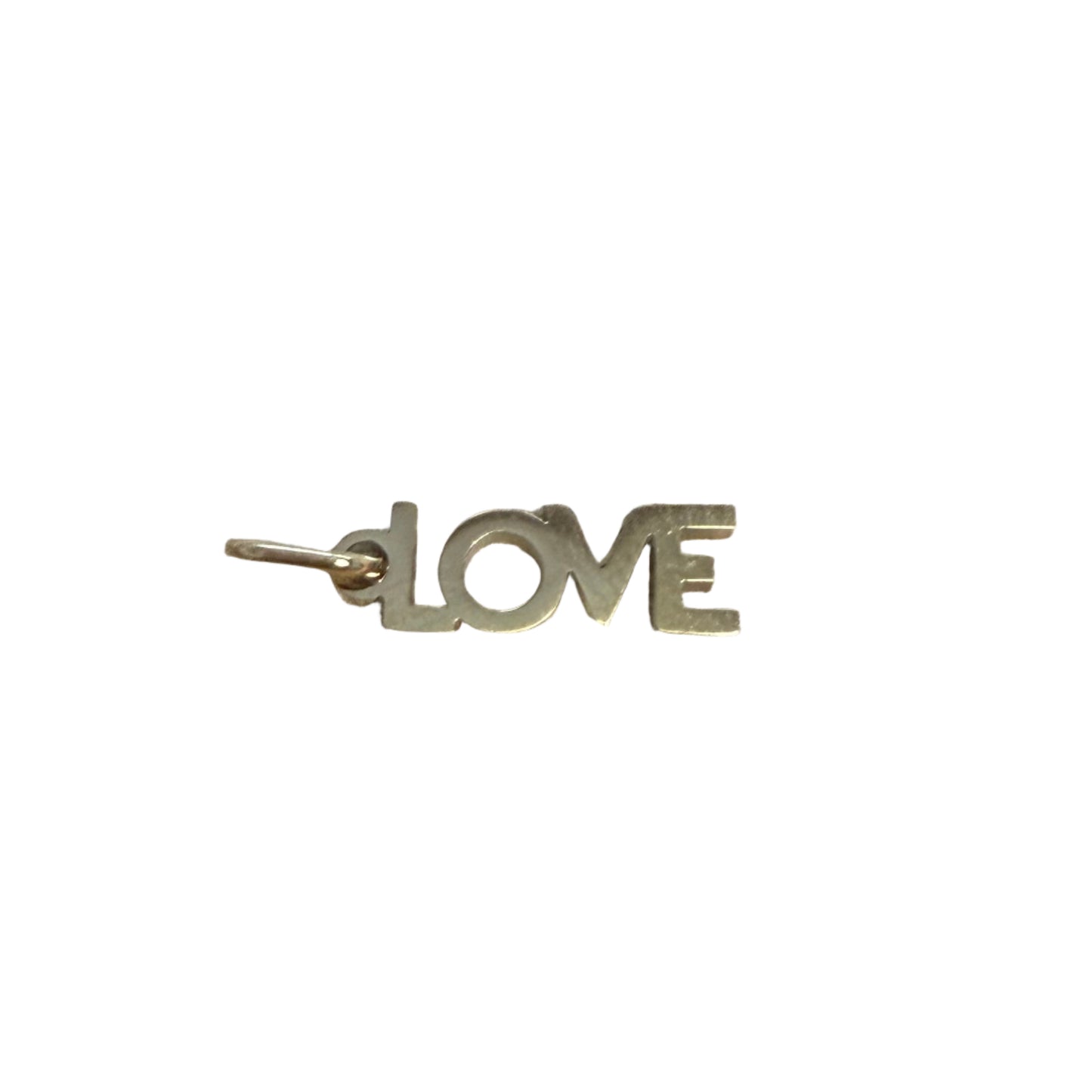 Metallic 'LOVE' charm on textured fabric surface
