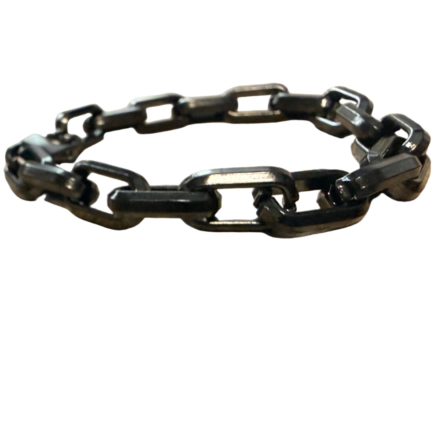 Black chain bracelet on a wooden surface with a blurred background