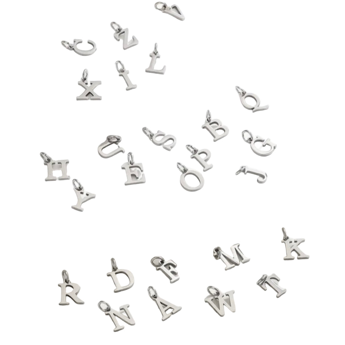 Silver letter pendants on a white fabric background