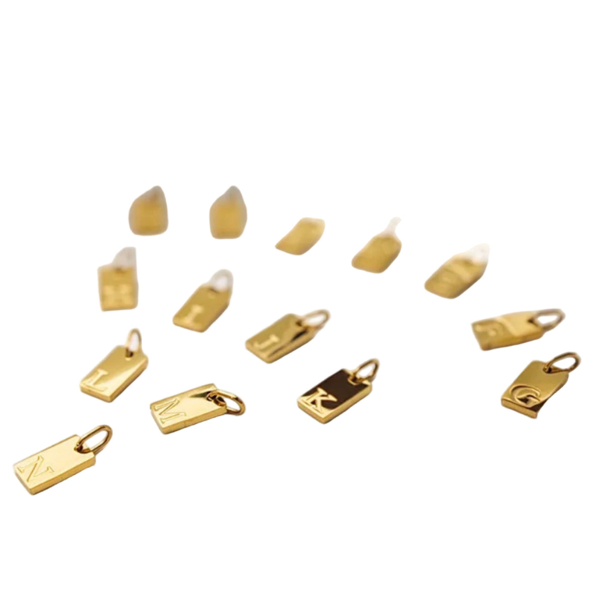 Gold charms on a white fabric background