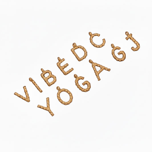 Gold metallic letter-shaped objects on a white background