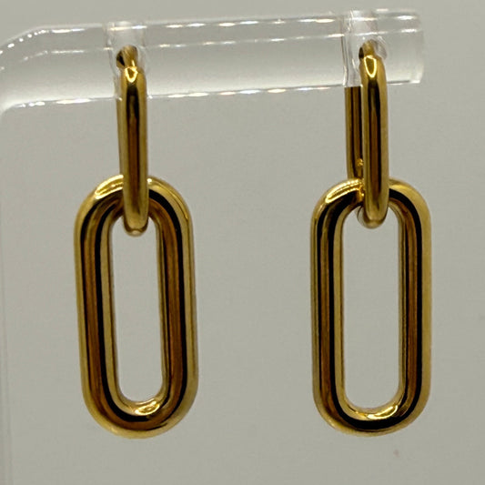 Gold chain-style earrings on a clear stand against a white background