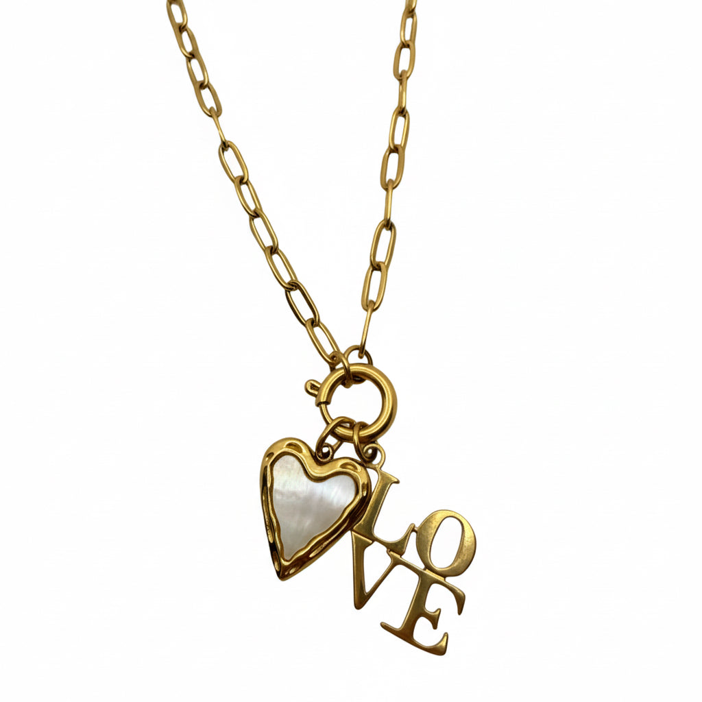 Gold necklace with heart and 'LOVE' pendant on a light gray background