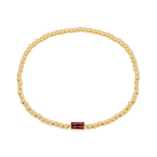 Gold bracelet with a red gemstone on a white background