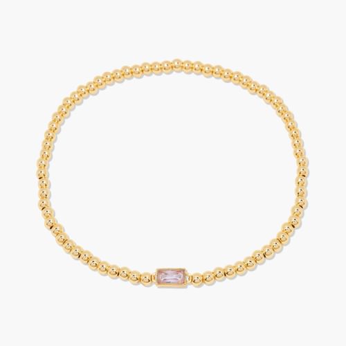 Gold bracelet with a pink gemstone on a white background