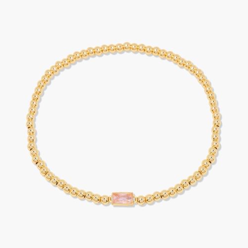 Gold bracelet with a pink gemstone on a white background