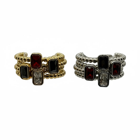 Two gold and silver rings with gemstones on a white background