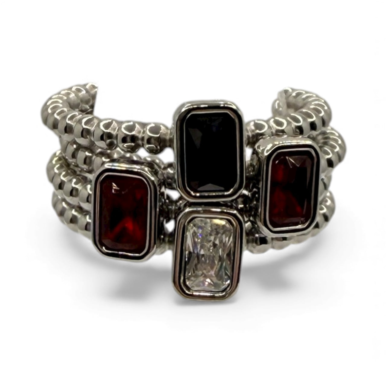 Silver bracelet with red and black gemstones on a white background