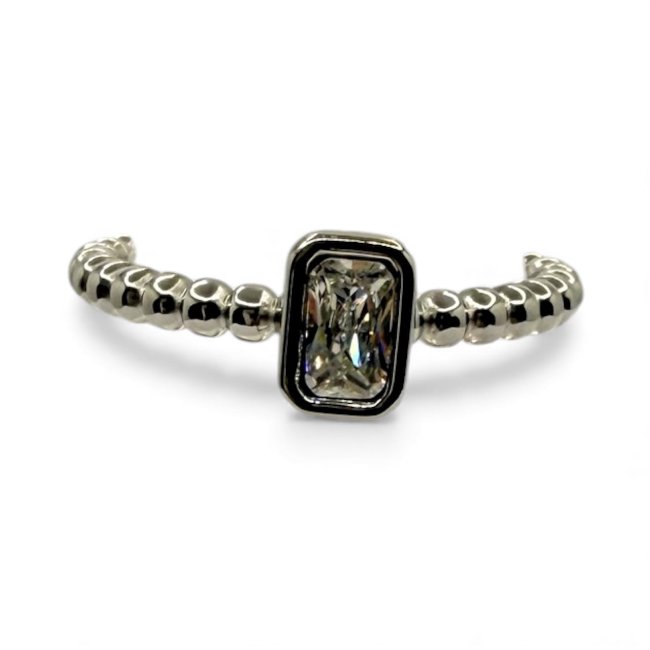 Silver ring with a rectangular gemstone on a white background