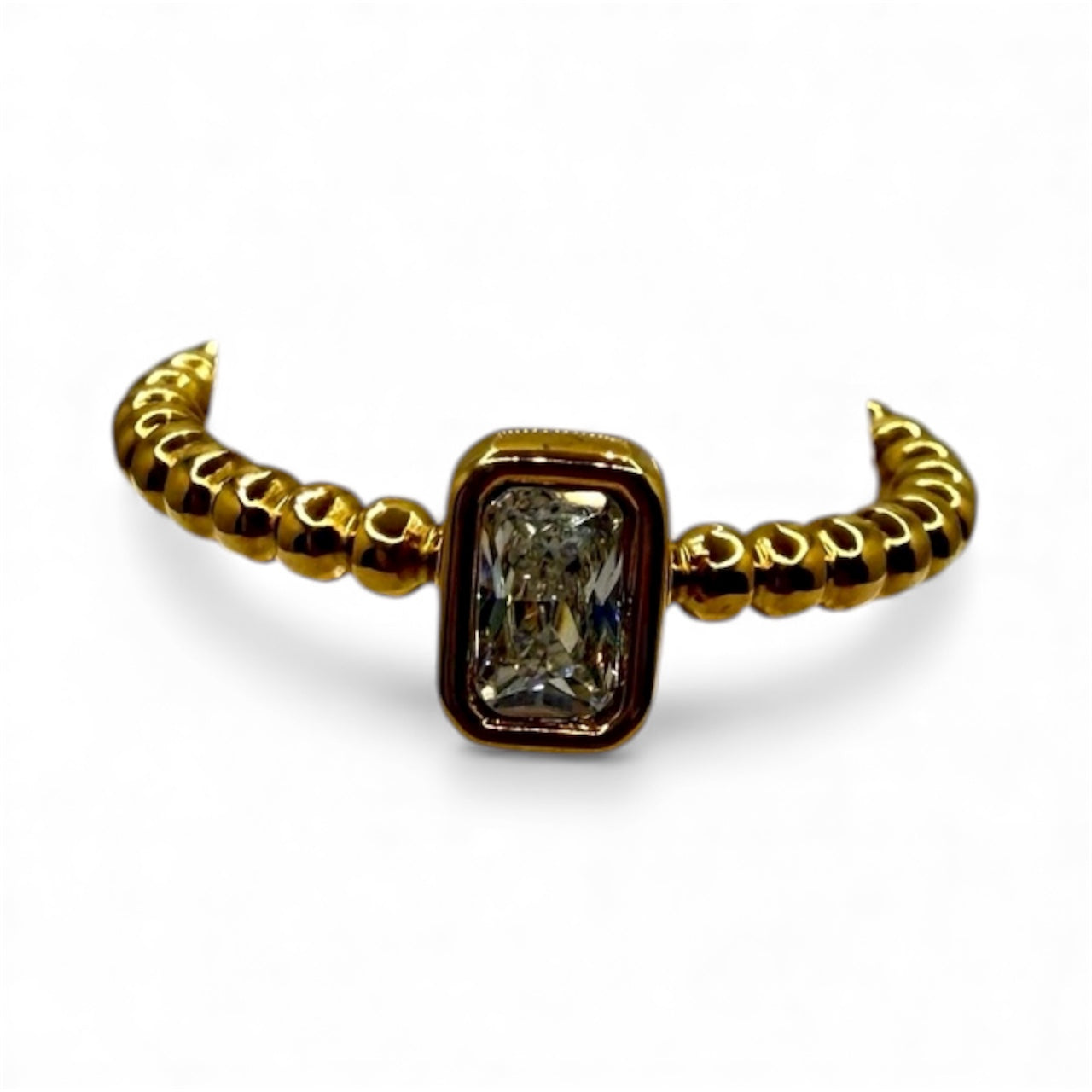 Gold ring with a central diamond on a white background