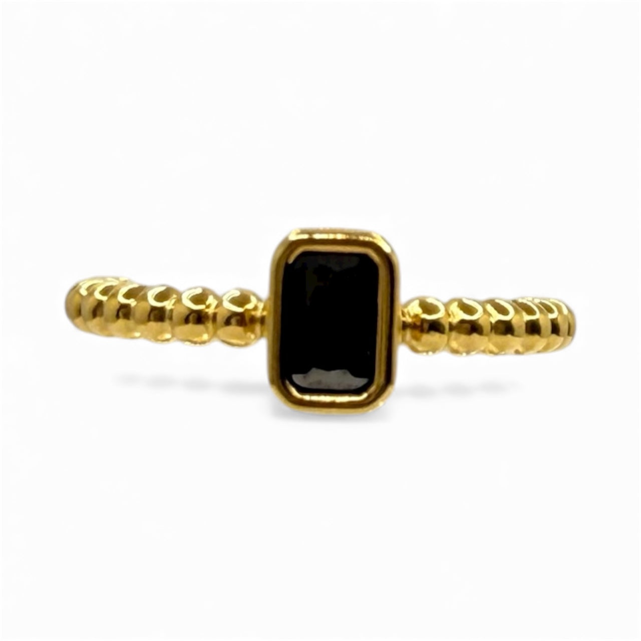 Gold ring with a black gemstone on a white background