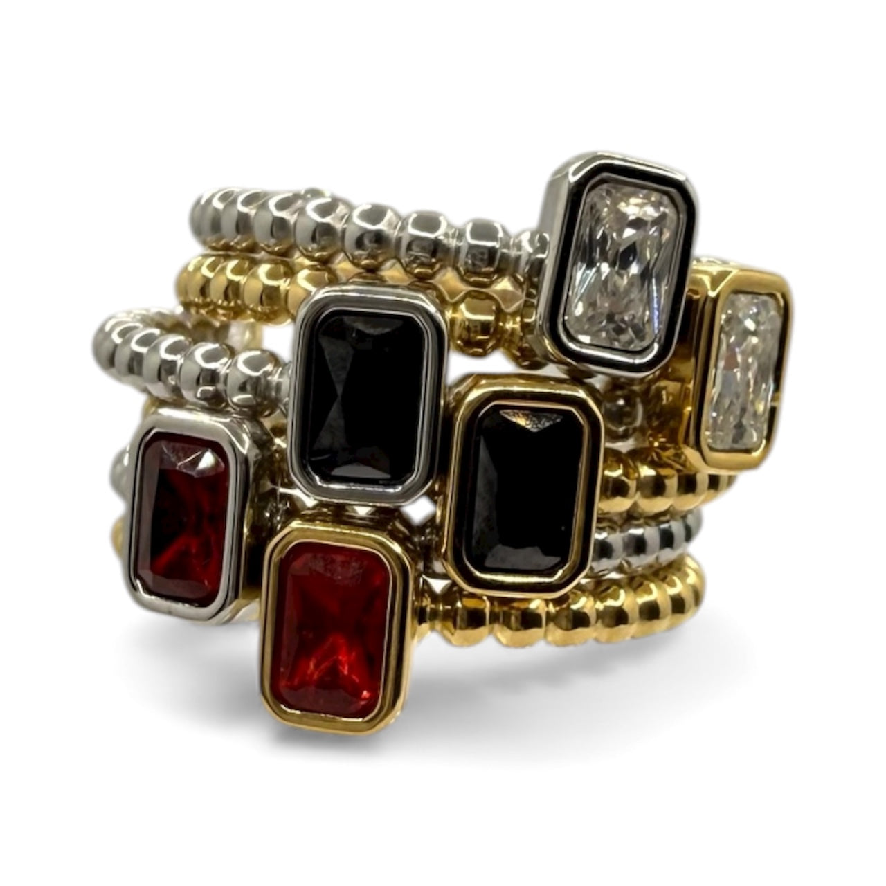 Set of gold, silver, and gemstone-encrusted rings on a white background