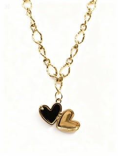 Gold necklace with heart-shaped pendants on a white background
