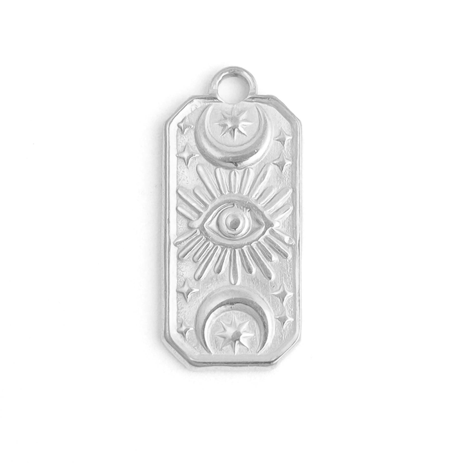 Silver pendant with engraved symbols on a white background