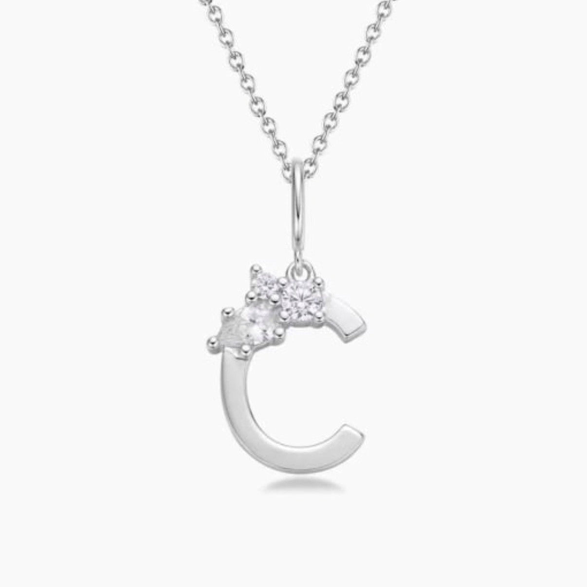 Silver necklace with a crescent moon pendant on a white background